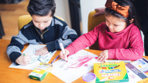 Children drawing with school supplies