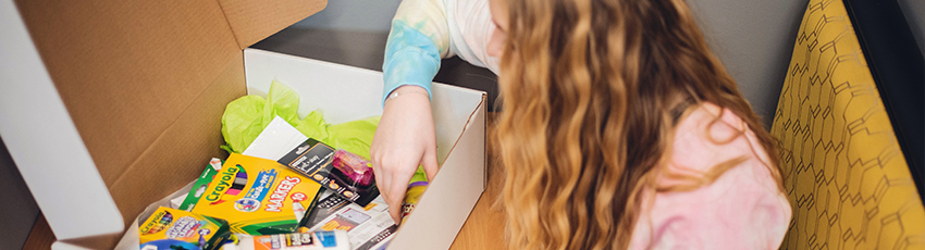 girl opens school supply kit