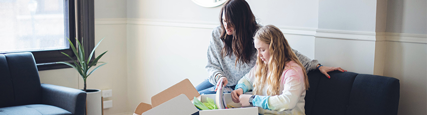 Mom and daughter look at school supplies