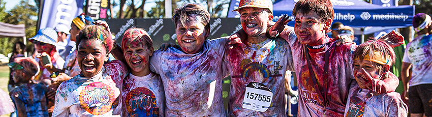 Kids smile at camera after color run